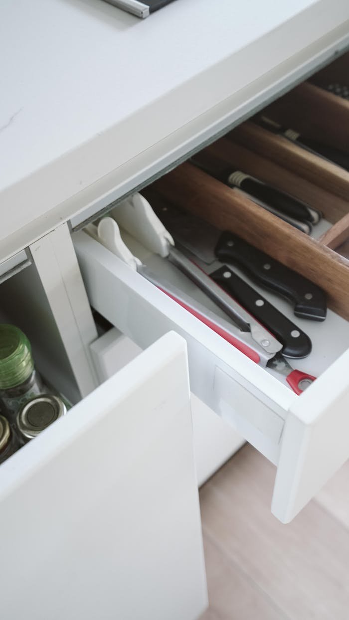 heros-img Neatly arranged kitchen drawer with knives and utensils, showcasing effective organization.